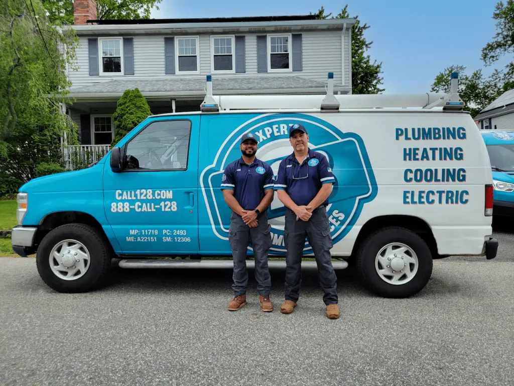 two men standing in front of a 128plumbing's van. Mass Save