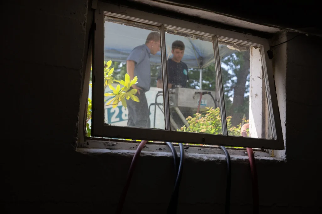 a window with a couple of men standing outside